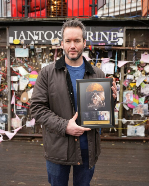 Gareth David-Lloyd with his Torchwood gold disc at Ianto's Shrine in Cardiff © Jonathon Aiken